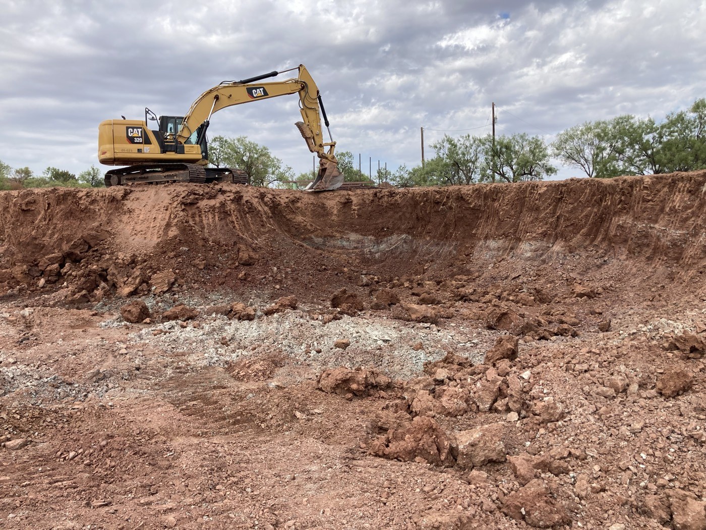 Excavator working a dirt mound