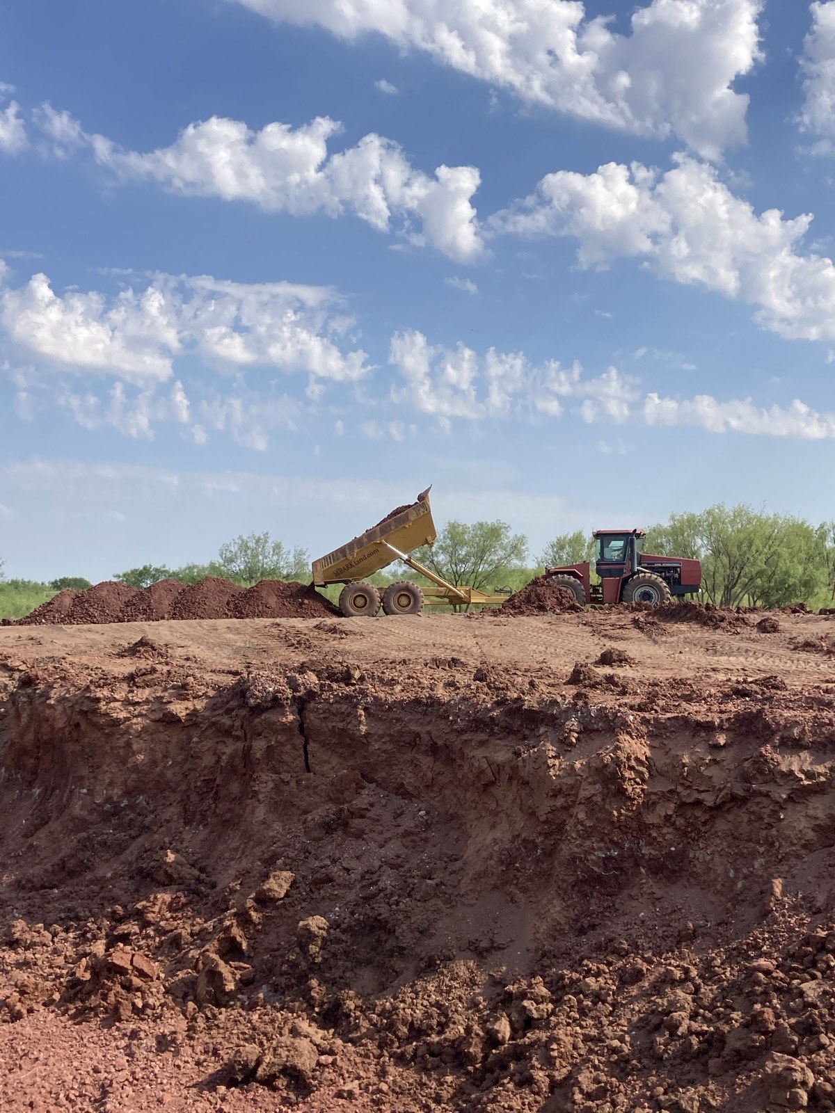 Excavator loading material into a dump truck